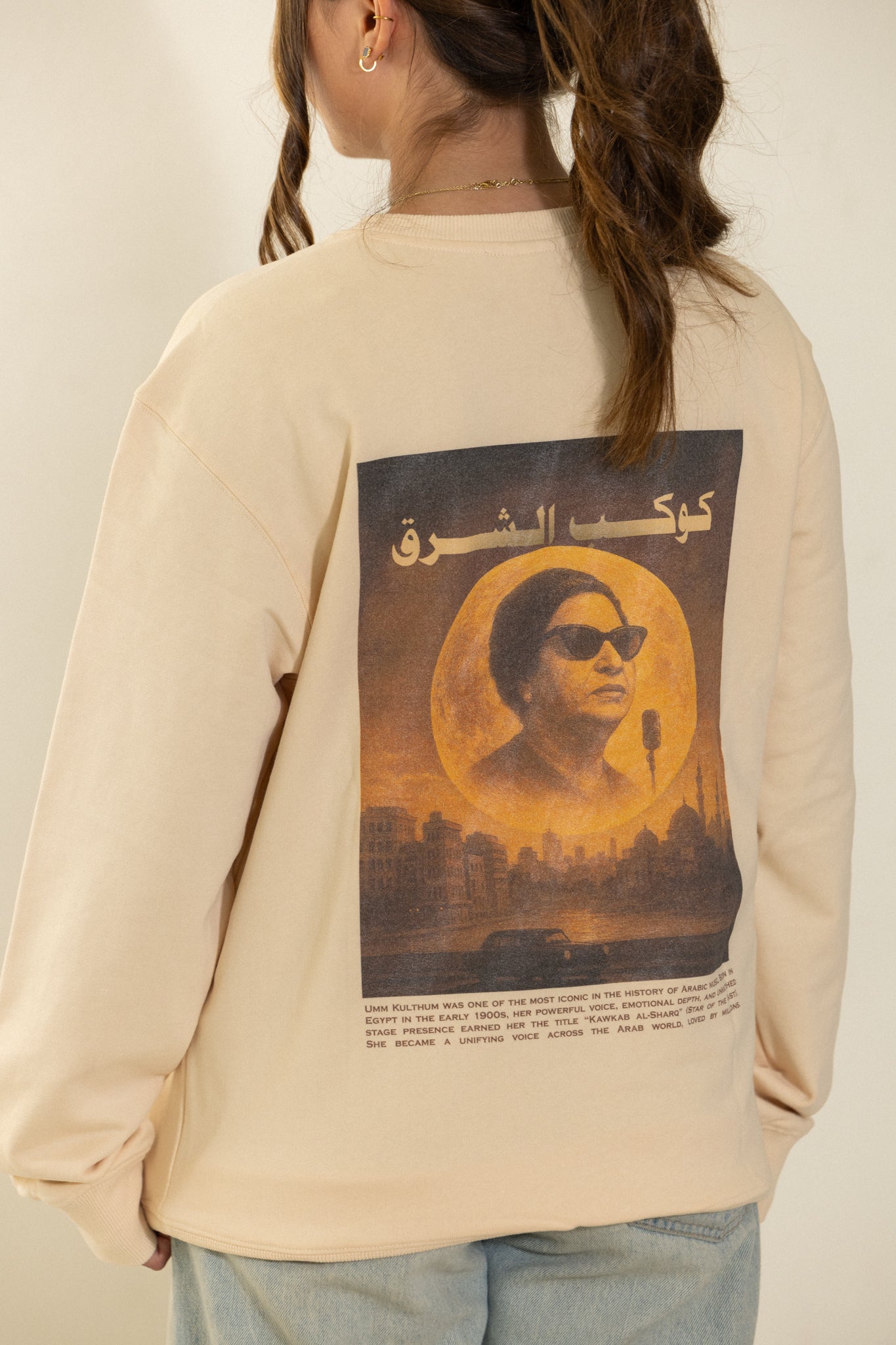 Arabic Heritage beige sweatshirt with a graphic Cairo Nights Umm Kulthum design on the back.
