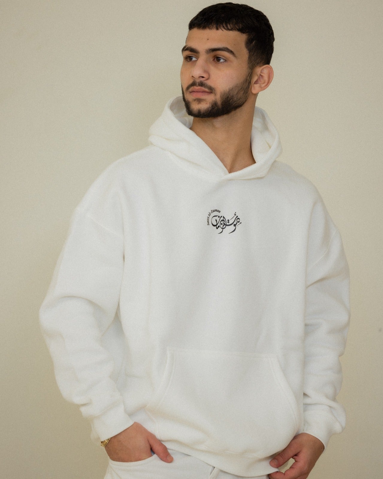 Studio view of the black Umm Kulthum El Sett hoodie featuring Arabic typography and portrait tribute artwork.
