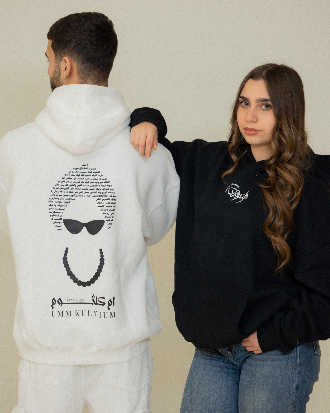 Black and white Umm Kulthum El Sett hoodies with Arabic typography, sunglasses and pearl necklace artwork.