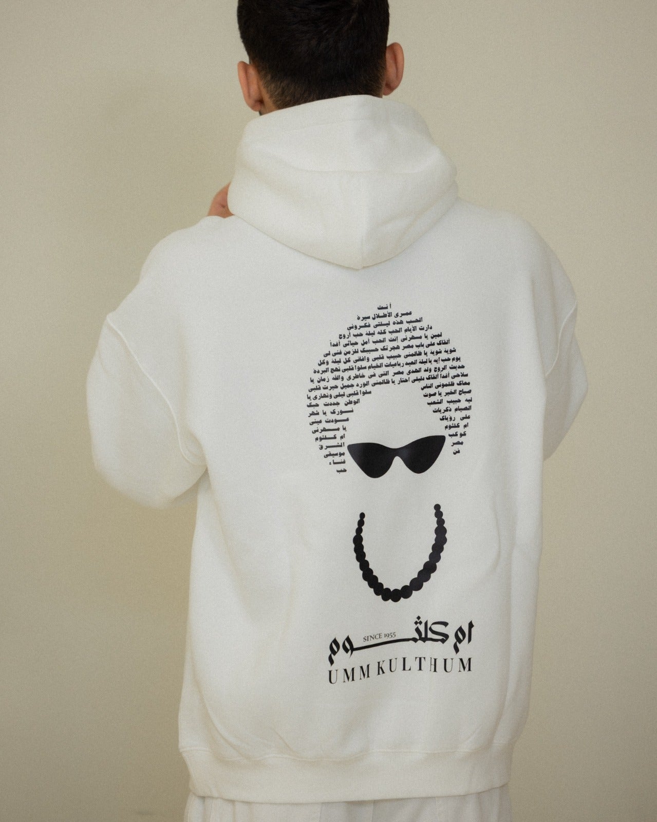 White Umm Kulthum El Sett hoodie artwork detail with Arabic song titles and classic Egyptian music imagery.